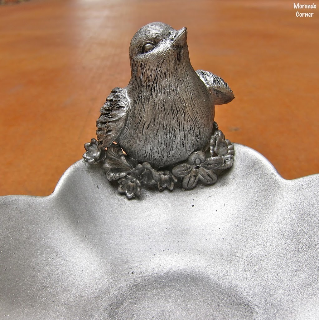 close up of faux pewter bird