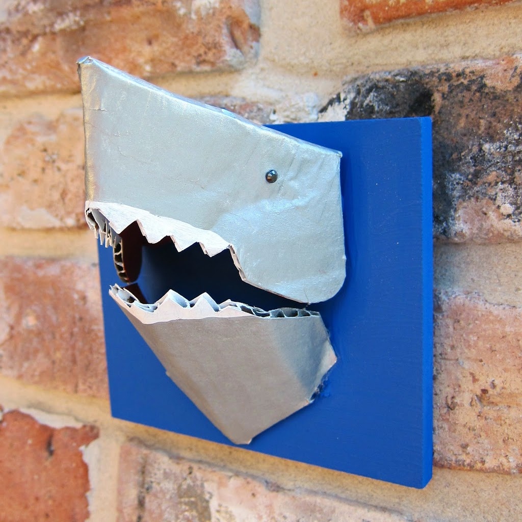 Make a 3-D shark jewelry holder from cardboard. Between all those teeth and the head you can hang quite a few items on this tiny but mighty shark.