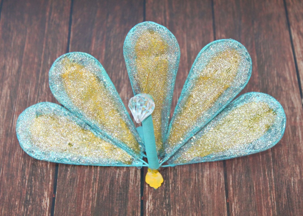 Turn a whisk into fun DIY peacock garden art.