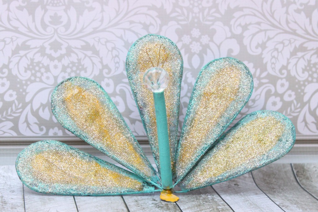Turn a whisk into fun DIY peacock garden art.