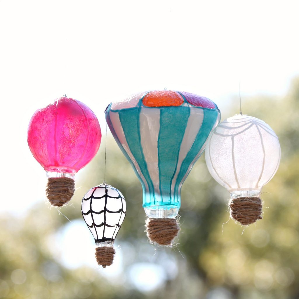 Make light bulb hot air balloons to create whimsical recycled decor. Perfect for Earth Day crafts or any day outdoor decor!