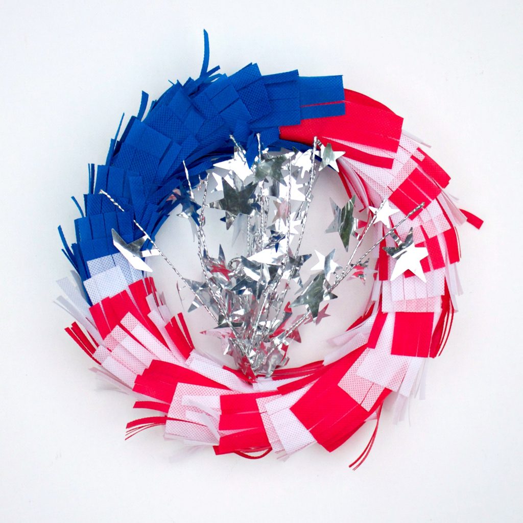 This quick project is quick and easy to make thanks to non-fraying Oly-Fun fabric!  Make an American flag wreath to decorate your home this fourth of July! 