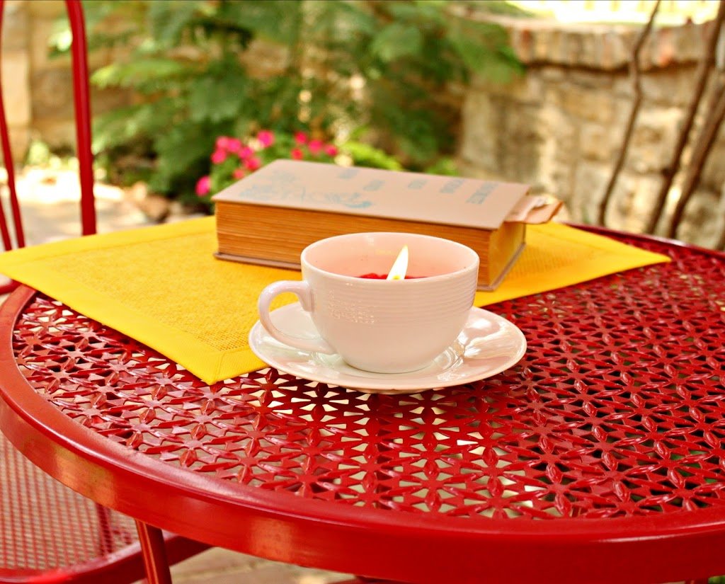 Use thrifted cups, saucers, and candles to create a lovely tea cup candle. These candles are just perfect for summer nights!