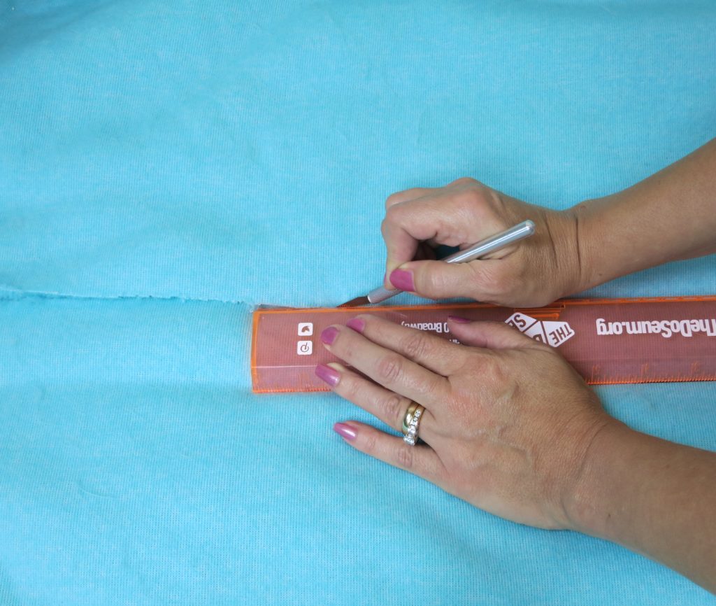 Transform an outdated ottoman from Goodwill San Antonio into a fun piece of dorm decor in under one hour! This ottoman slipcover DIY is Easy to make.