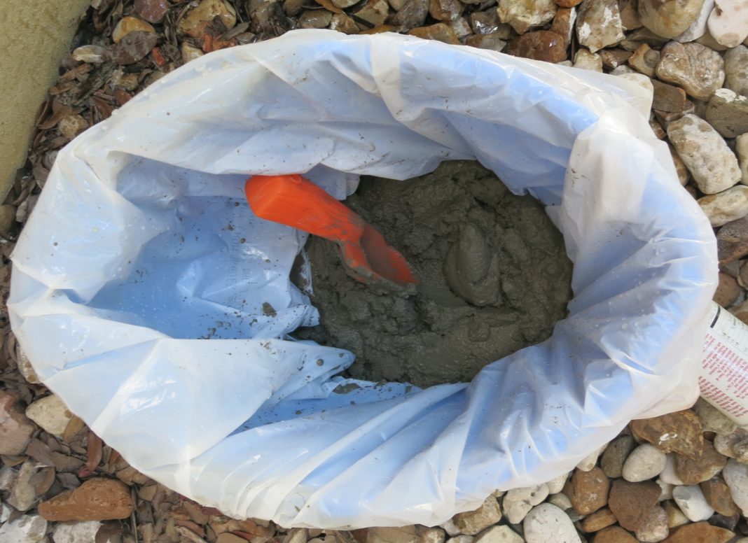 mix cement in bucket to make planter