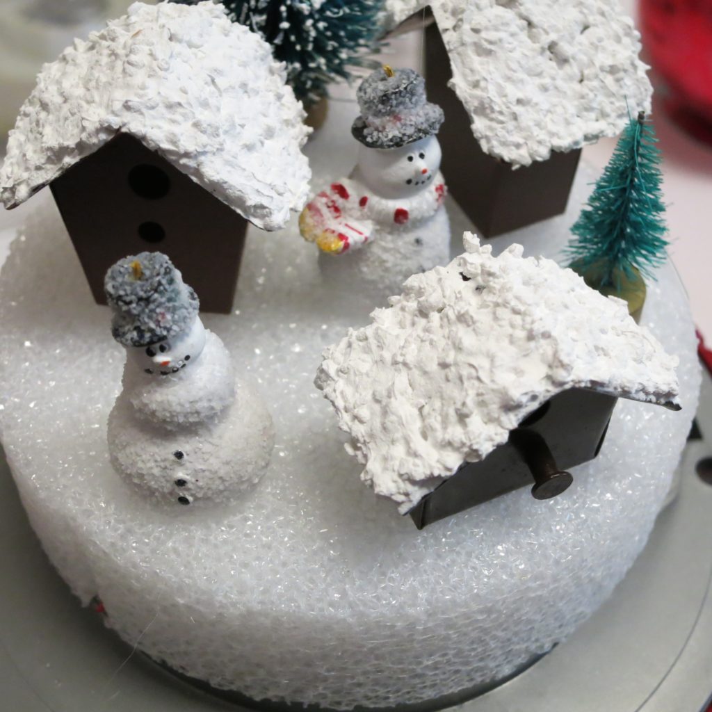 Make a gumball machine snow globe using a thrift store item with various craft supplies. Make adorable holiday Christmas and winter decor!