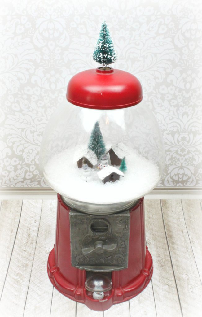 Make a gumball machine snow globe using a thrift store item with various craft supplies. Make adorable holiday Christmas and winter decor!