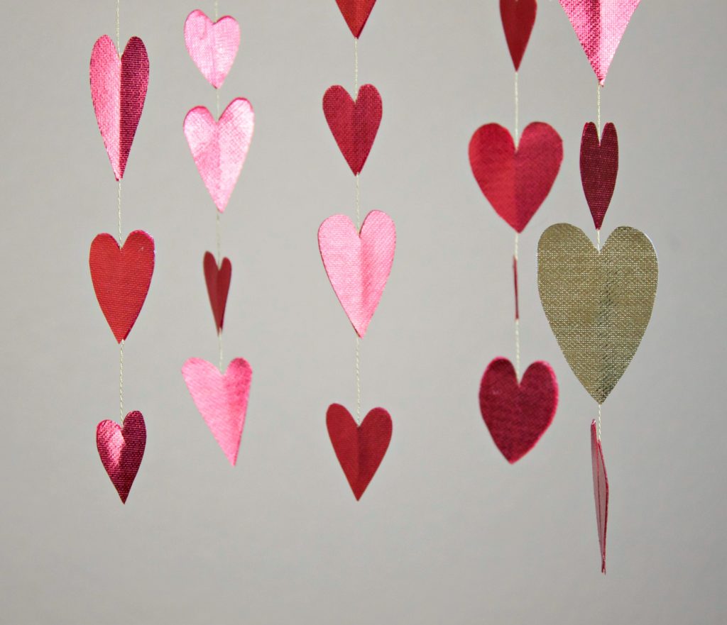 Make a shimmery heart mobile to decorate your room with for Valentine's day!
