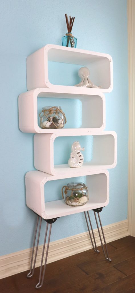 This mod shelf DIY is my version of an expensive furniture item. I used wood floating shelves PLUS a table from Goodwill to make my own storage shelf.