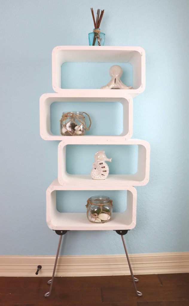 This mod shelf DIY is my version of an expensive furniture item. I used wood floating shelves PLUS a table from Goodwill to make my own storage shelf.