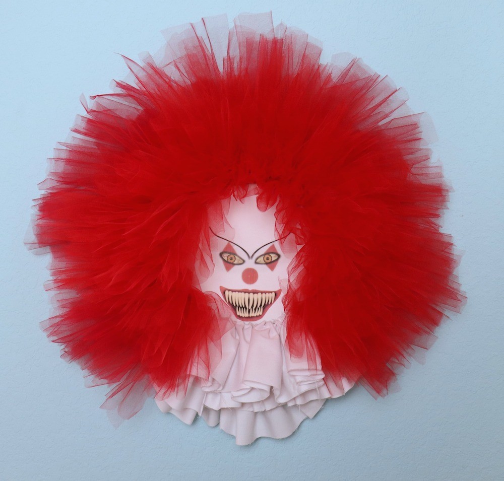 Make a scary clown wreath that is inspired by creepy Pennywise from the hit movie and book "It". Tutorial includes a free printable.