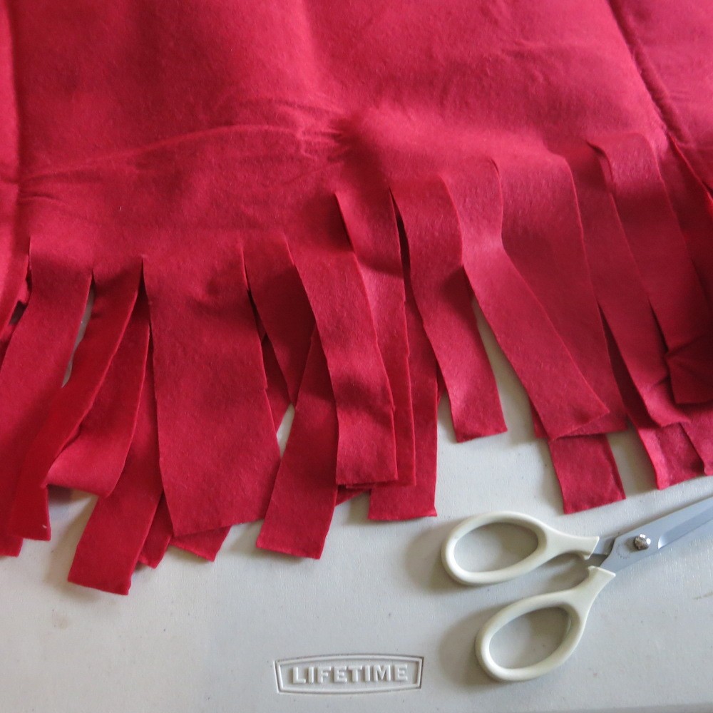 Cut fringe for giant snowman hat