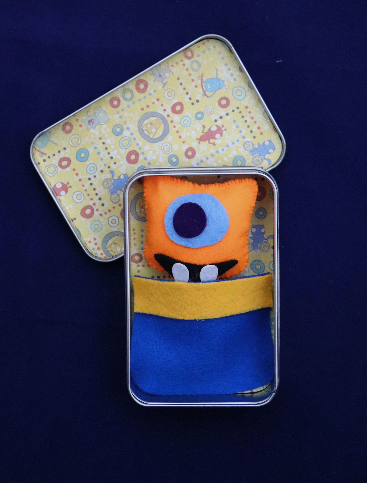 monster plush in a tin