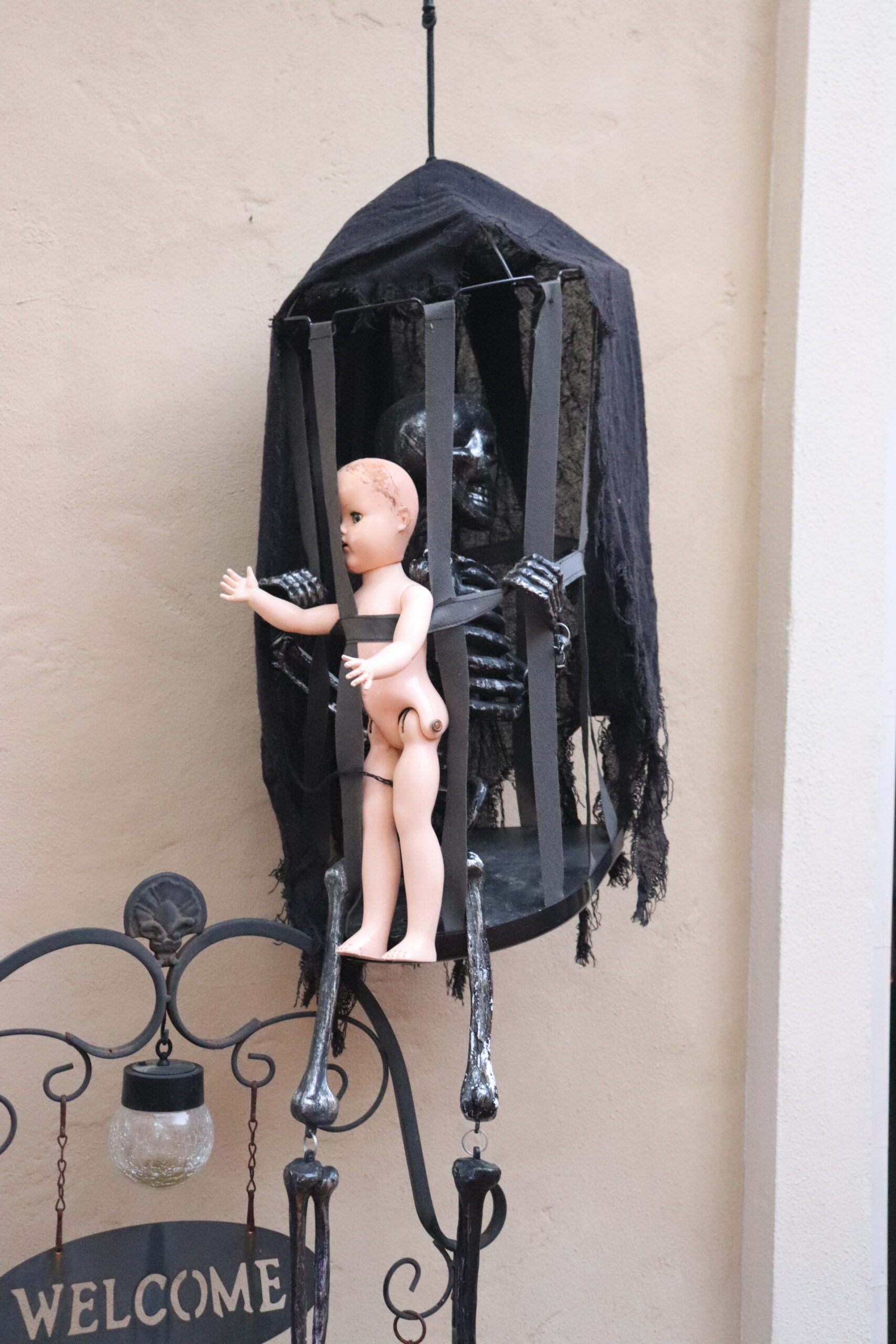 creepy doll in cage